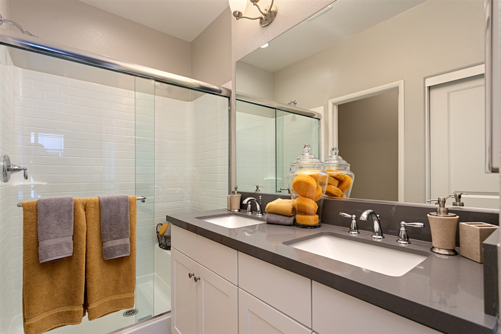 8850 Olive Lane, Unit 9 Santee, CA 92071 - Photo 11 of 17 The Master Bath includes the Thermofoil white cabinets, quartz countertops, Moen fixtures and modern square Kohler sinks. This is a picture of the new furnished model.