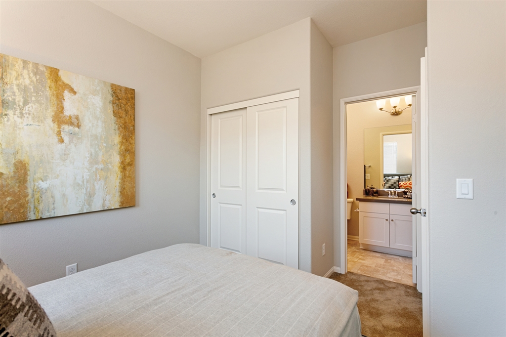 8850 Olive Lane, Unit 9 Santee, CA 92071 - Photo 13 of 17 The second bedroom upstairs serves as a dual master with a large closet and ensuite bathroom. This is a picture of the new furnished model.