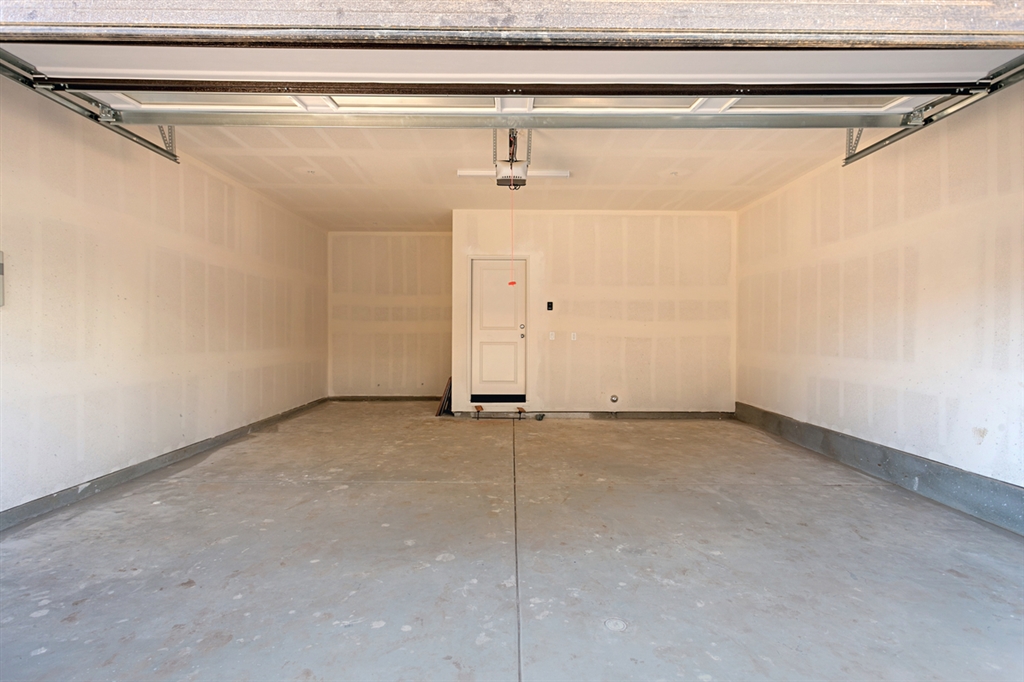 8850 Olive Lane, Unit 9 Santee, CA 92071 - Photo 15 of 17 The attached 2 car garage has direct access to the home. It is oversized with a perfect space for a workbench, craft space or extra storage.