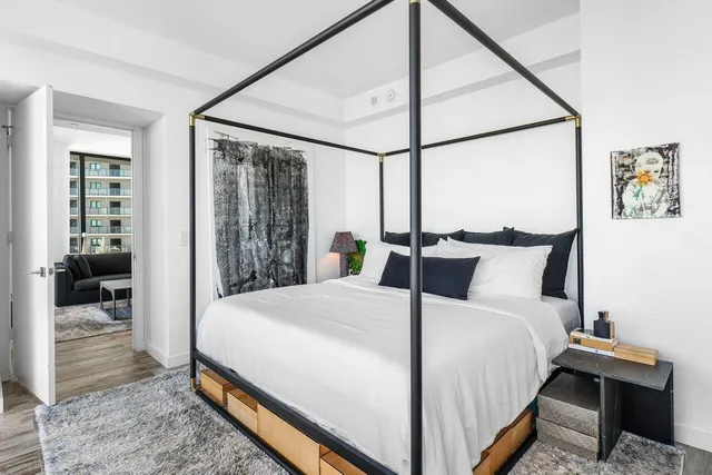 a bedroom with a bed and a mirror