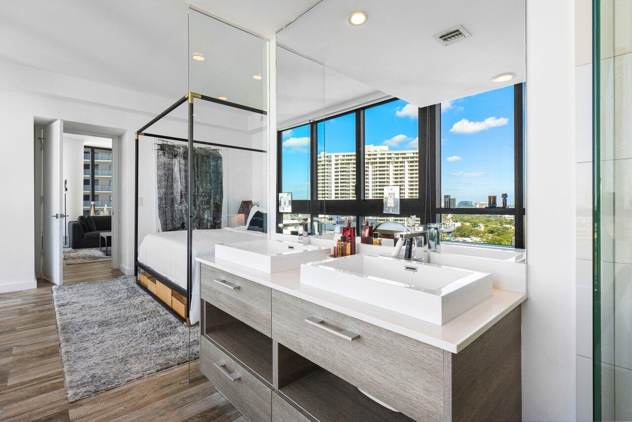 650 Northeast 32nd Street, Unit 1508 Miami, FL 33137 - Photo 17 of 37 a bathroom with a double vanity sink mirror and shower