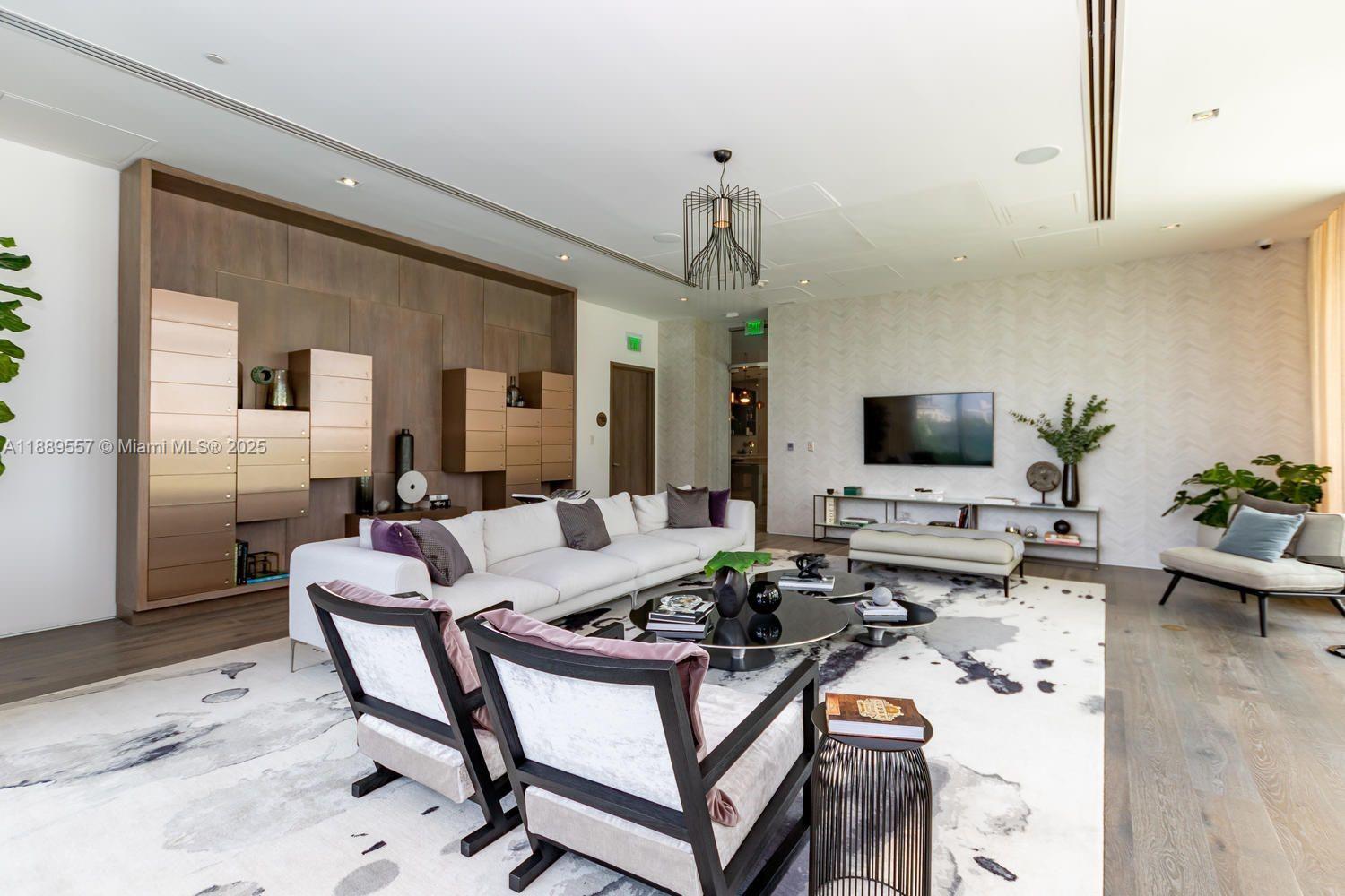 650 Northeast 32nd Street, Unit 1508 Miami, FL 33137 - Photo 29 of 37 a living room with furniture and a flat screen tv