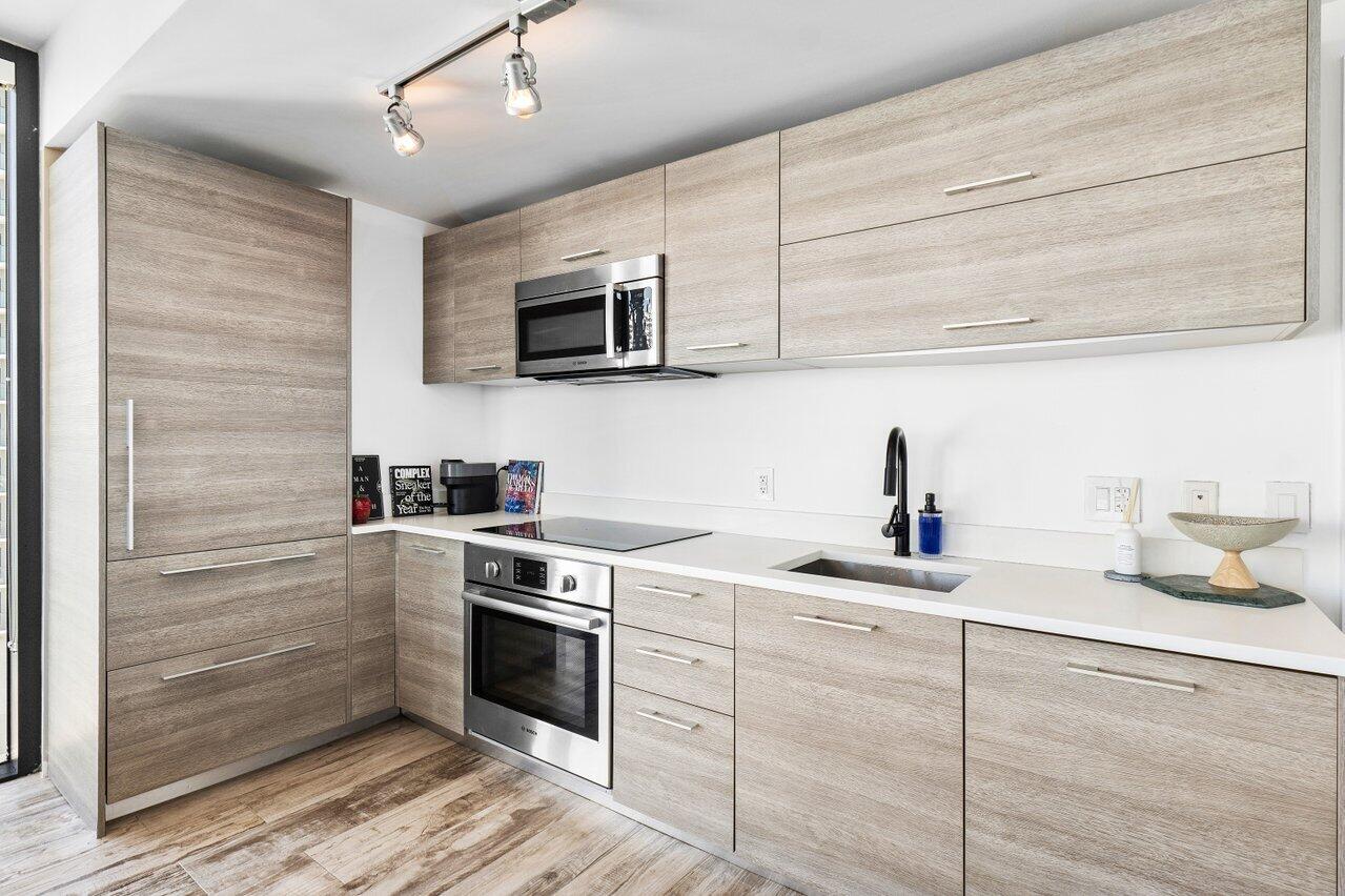 650 Northeast 32nd Street, Unit 1508 Miami, FL 33137 - Photo 3 of 37 a kitchen with cabinets stainless steel appliances and sink