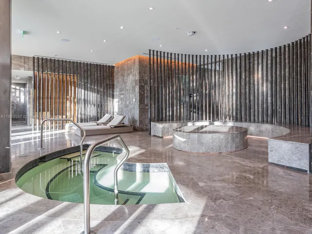 a living room with furniture a window and a chandelier