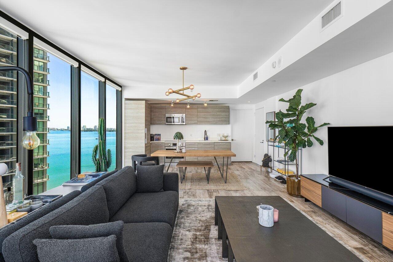 650 Northeast 32nd Street, Unit 1508 Miami, FL 33137 - Photo 9 of 37 a living room with furniture and a flat screen tv