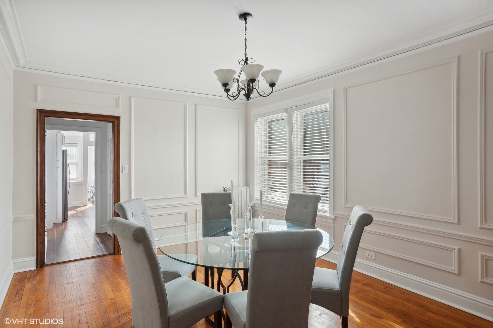 559 West Roscoe Street, Unit 2W Chicago, IL 60657 - Photo 11 of 23 a view of a dining room with furniture window and wooden floor