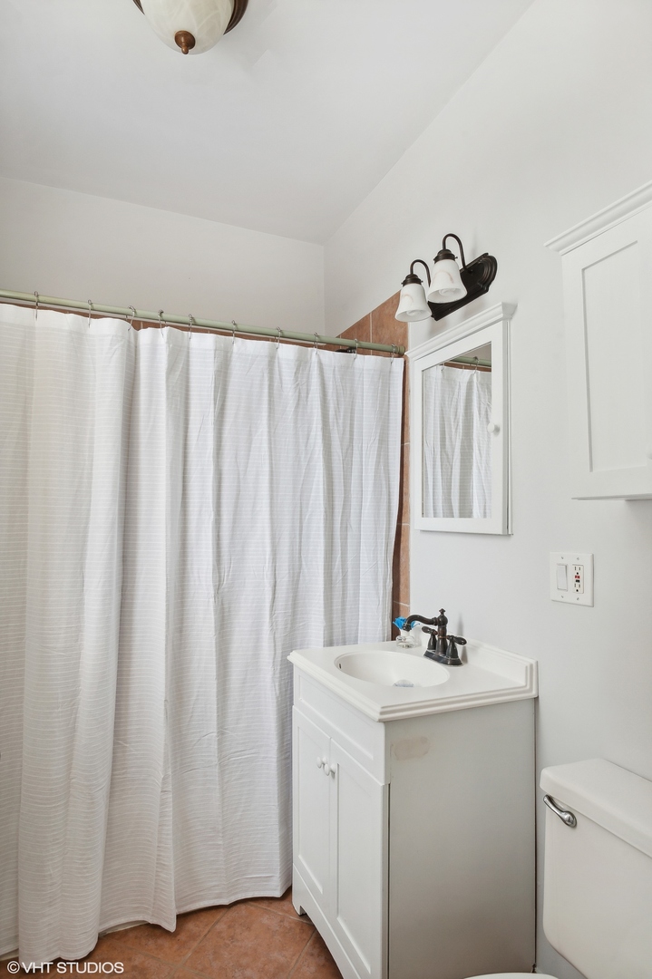 559 West Roscoe Street, Unit 2W Chicago, IL 60657 - Photo 14 of 23 a bathroom with a sink and a mirror