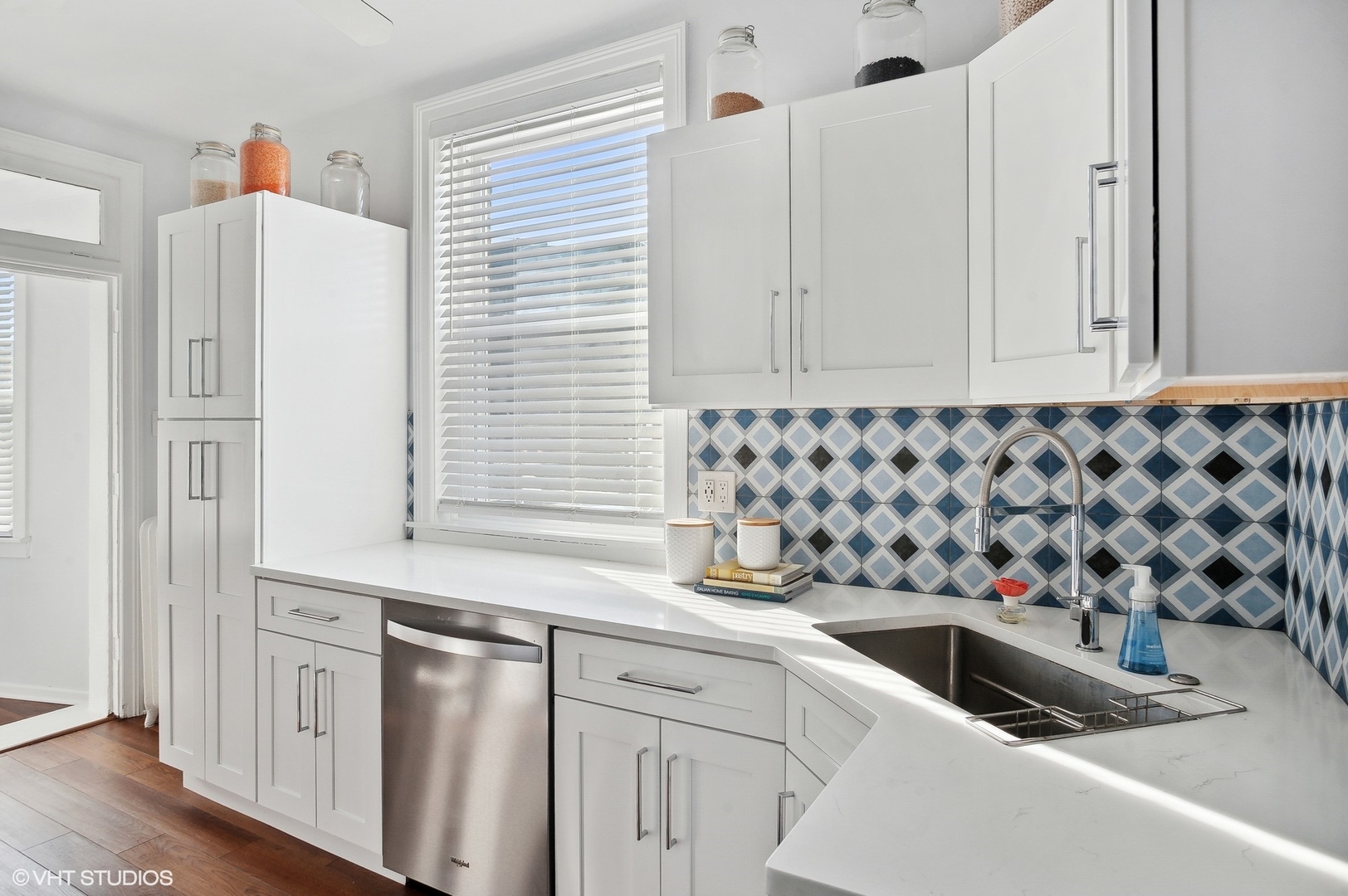 559 West Roscoe Street, Unit 2W Chicago, IL 60657 - Photo 18 of 23 a kitchen with a sink and a refrigerator