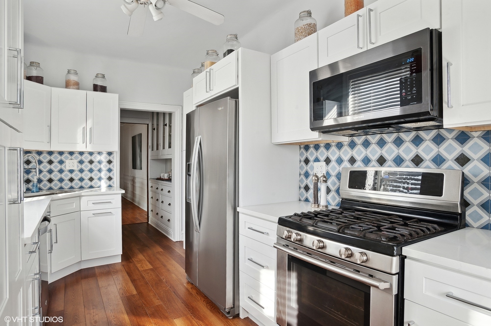 559 West Roscoe Street, Unit 2W Chicago, IL 60657 - Photo 20 of 23 a kitchen with stainless steel appliances a stove a microwave and cabinets