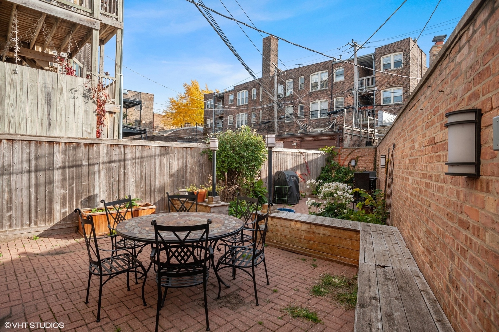 559 West Roscoe Street, Unit 2W Chicago, IL 60657 - Photo 22 of 23 a view of a patio with table and chairs and potted plants