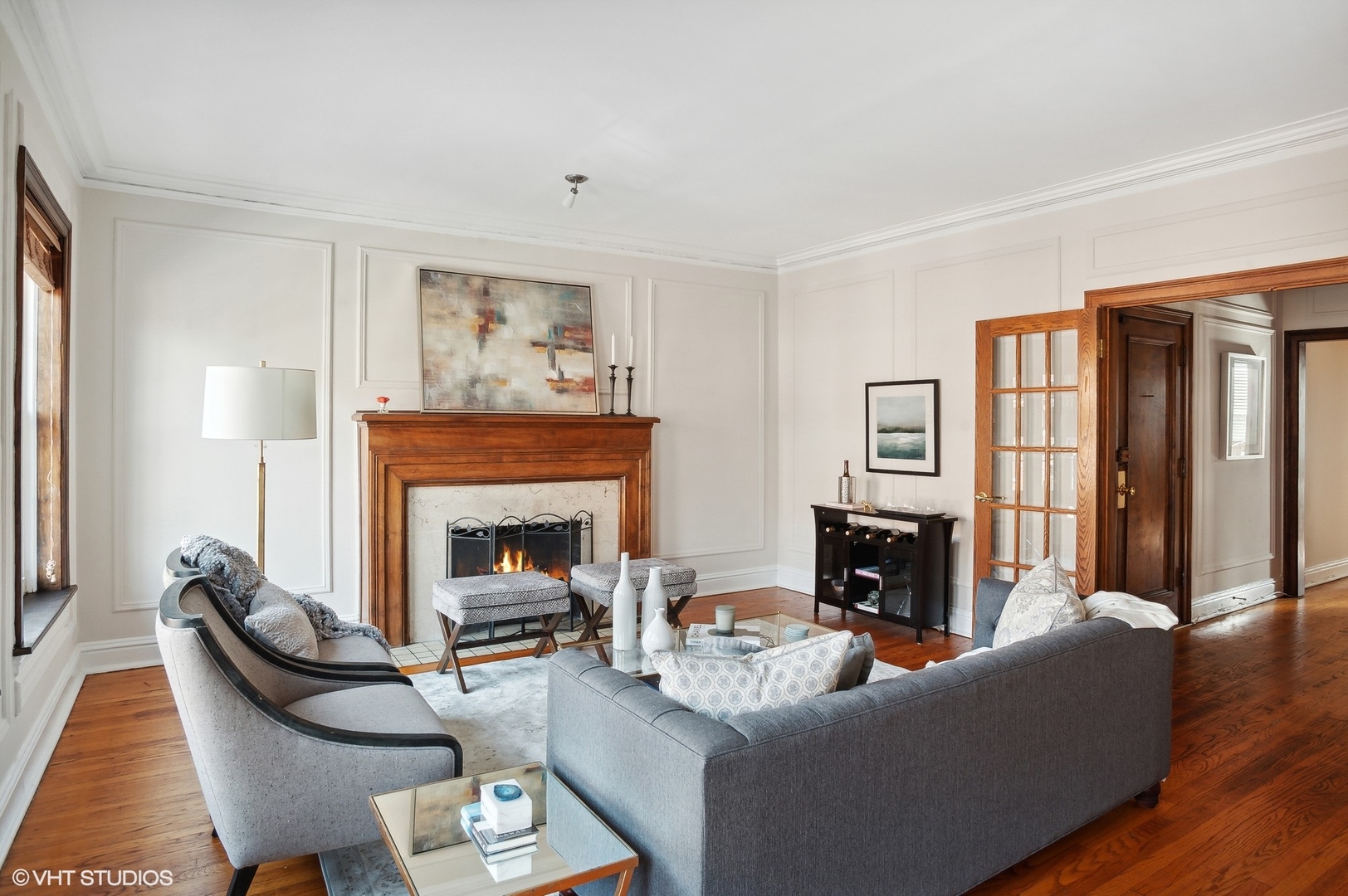 559 West Roscoe Street, Unit 2W Chicago, IL 60657 - Photo 4 of 23 a living room with furniture a fireplace and a window