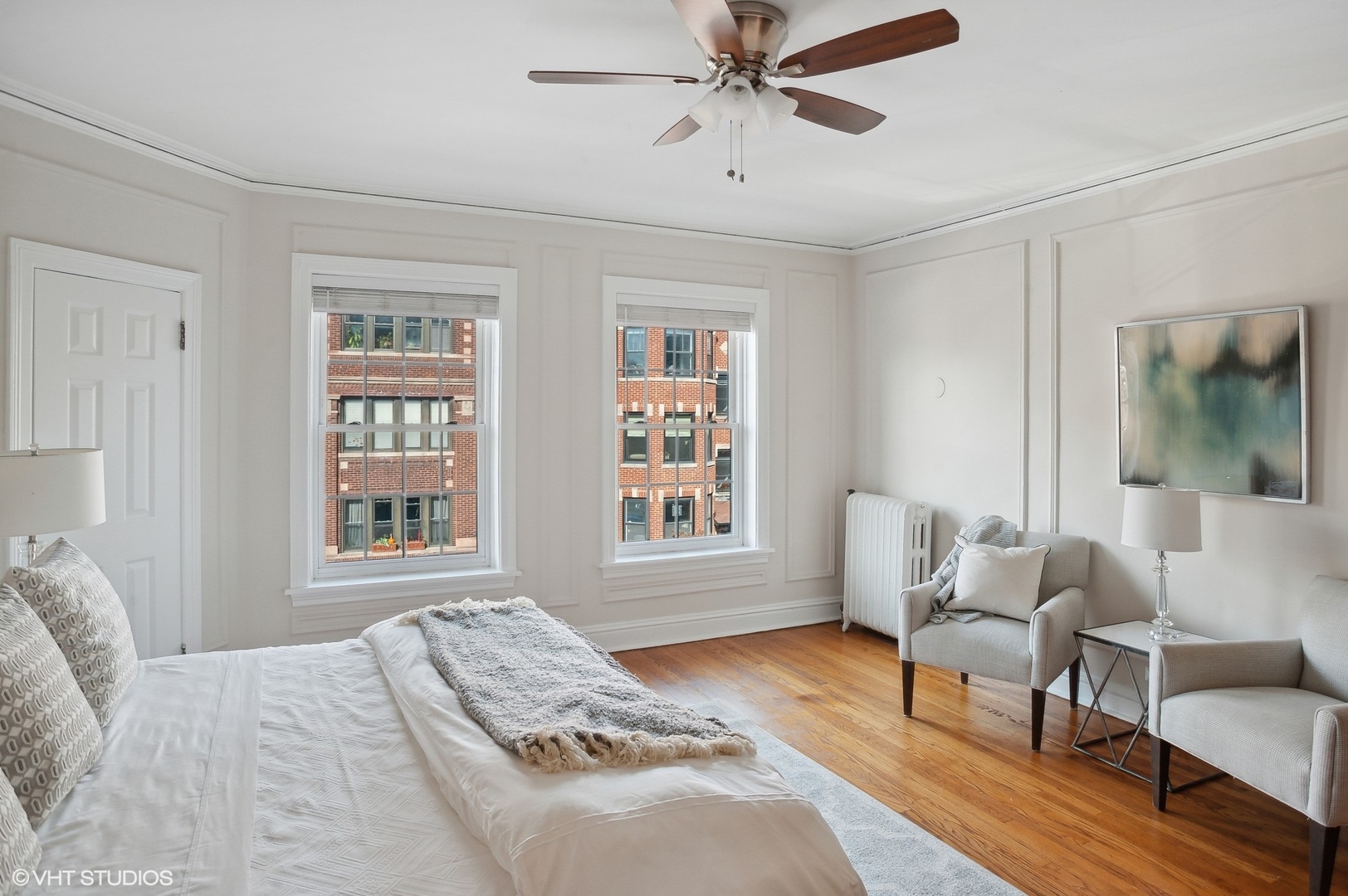 559 West Roscoe Street, Unit 2W Chicago, IL 60657 - Photo 8 of 23 a bedroom with a bed furniture and wooden floor
