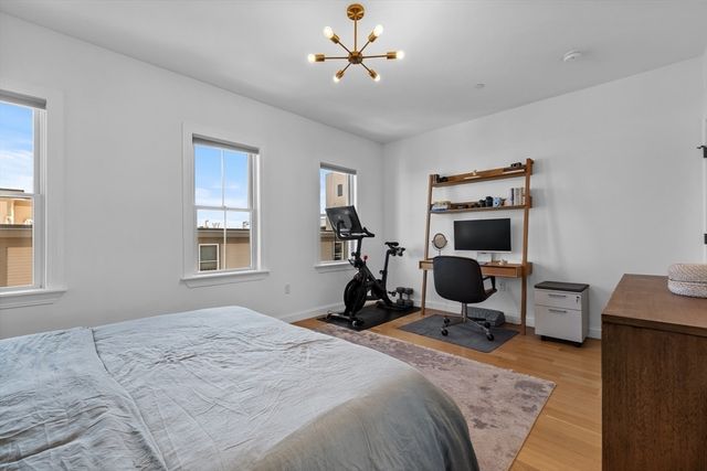 a bedroom with bed and a chandelier