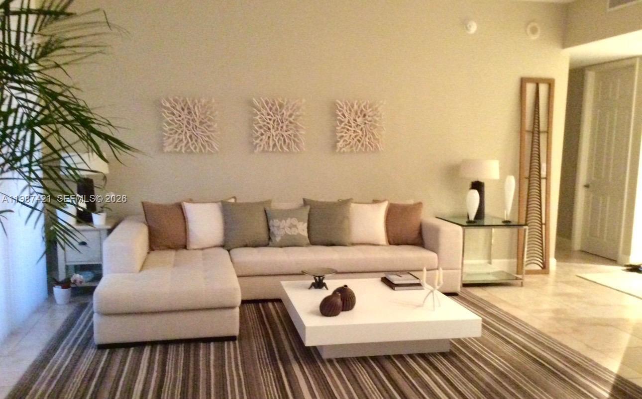 55 Merrick Way, Unit 825 Coral Gables, FL 33134 - Photo 1 of 26 a bedroom with a bed and a couch