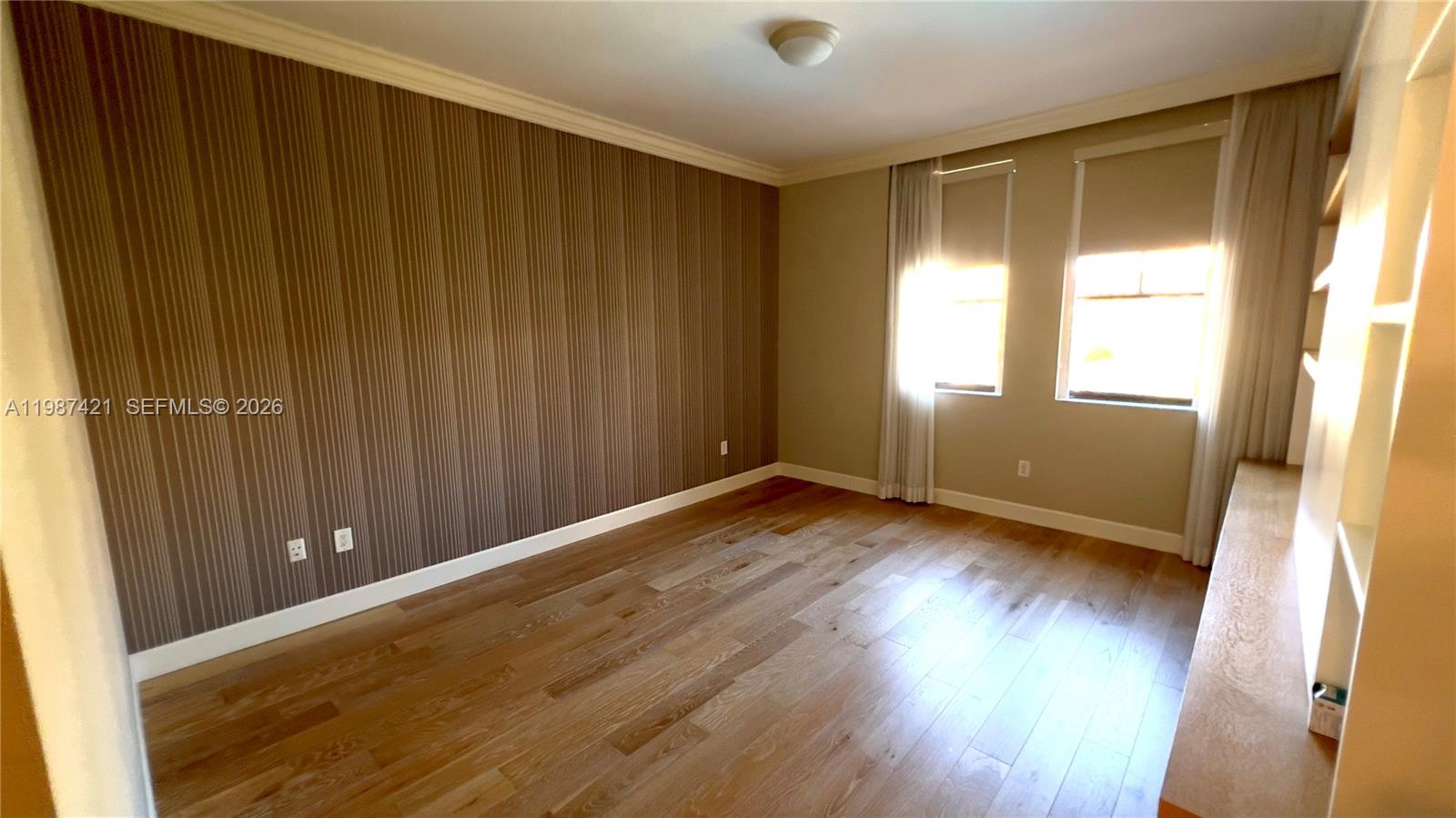 55 Merrick Way, Unit 825 Coral Gables, FL 33134 - Photo 11 of 26 an empty room with wooden floor and windows