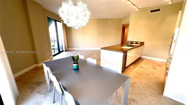 a view of a dining room with furniture and a chandelier