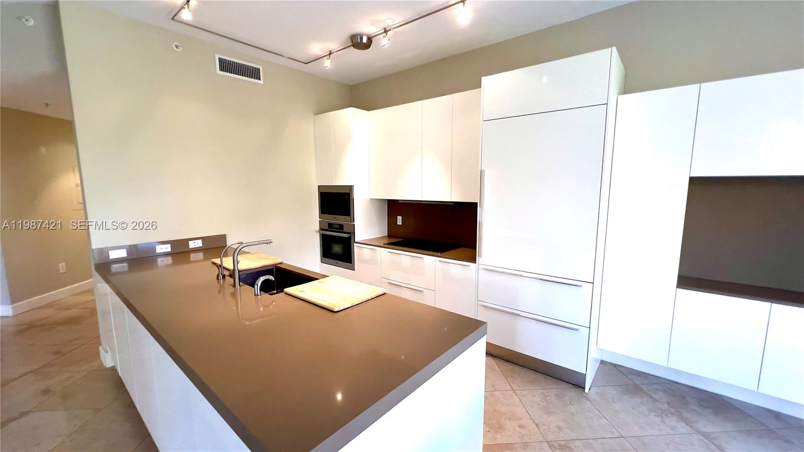 55 Merrick Way, Unit 825 Coral Gables, FL 33134 - Photo 13 of 26 a room with a bed and a flat screen tv