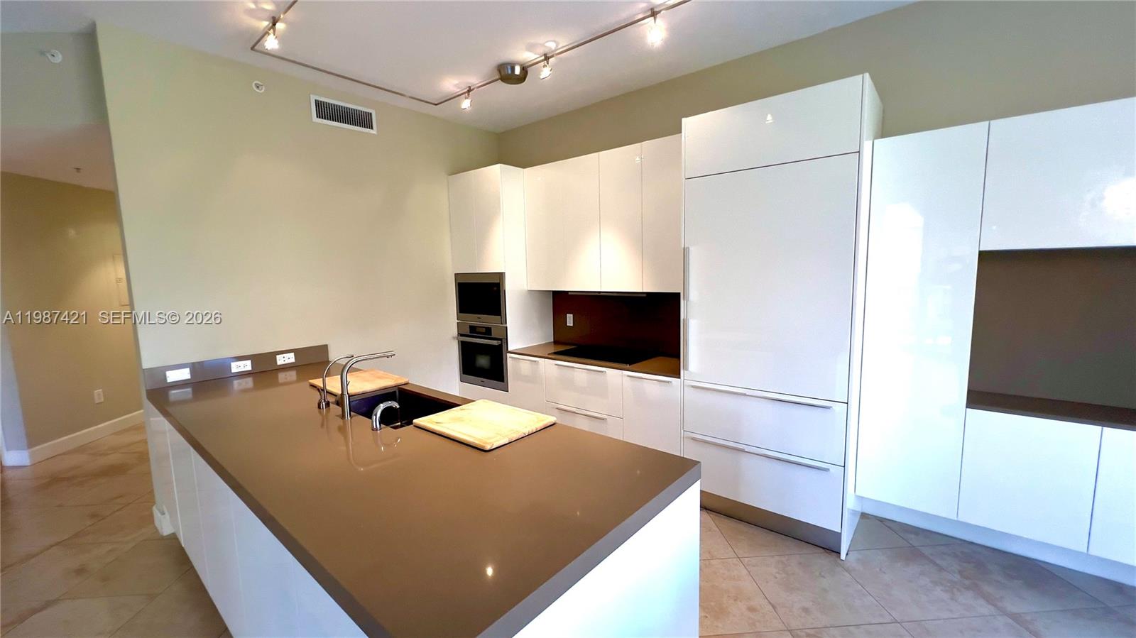 55 Merrick Way, Unit 825 Coral Gables, FL 33134 - Photo 14 of 26 a bedroom with a bed and a flat screen tv