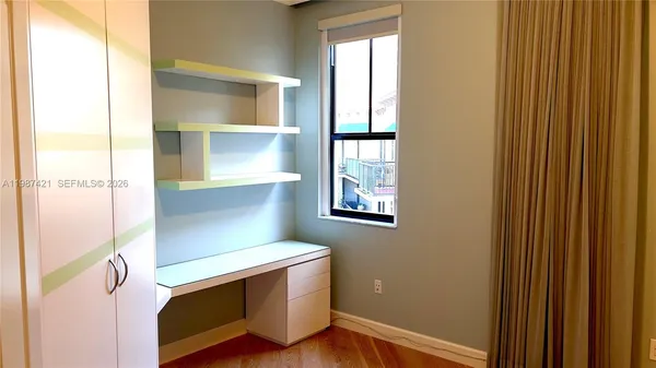 a room with a wooden floor and window