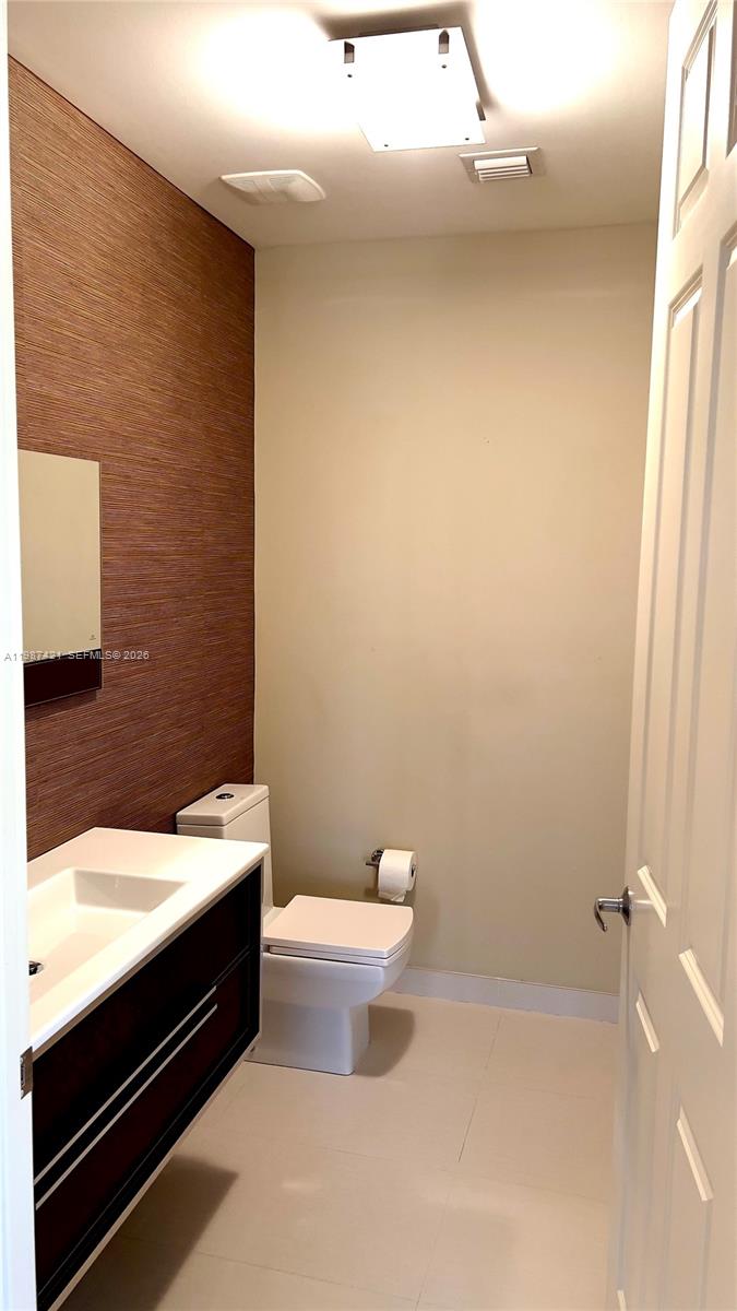 55 Merrick Way, Unit 825 Coral Gables, FL 33134 - Photo 17 of 26 a bathroom with a sink a toilet and a mirror