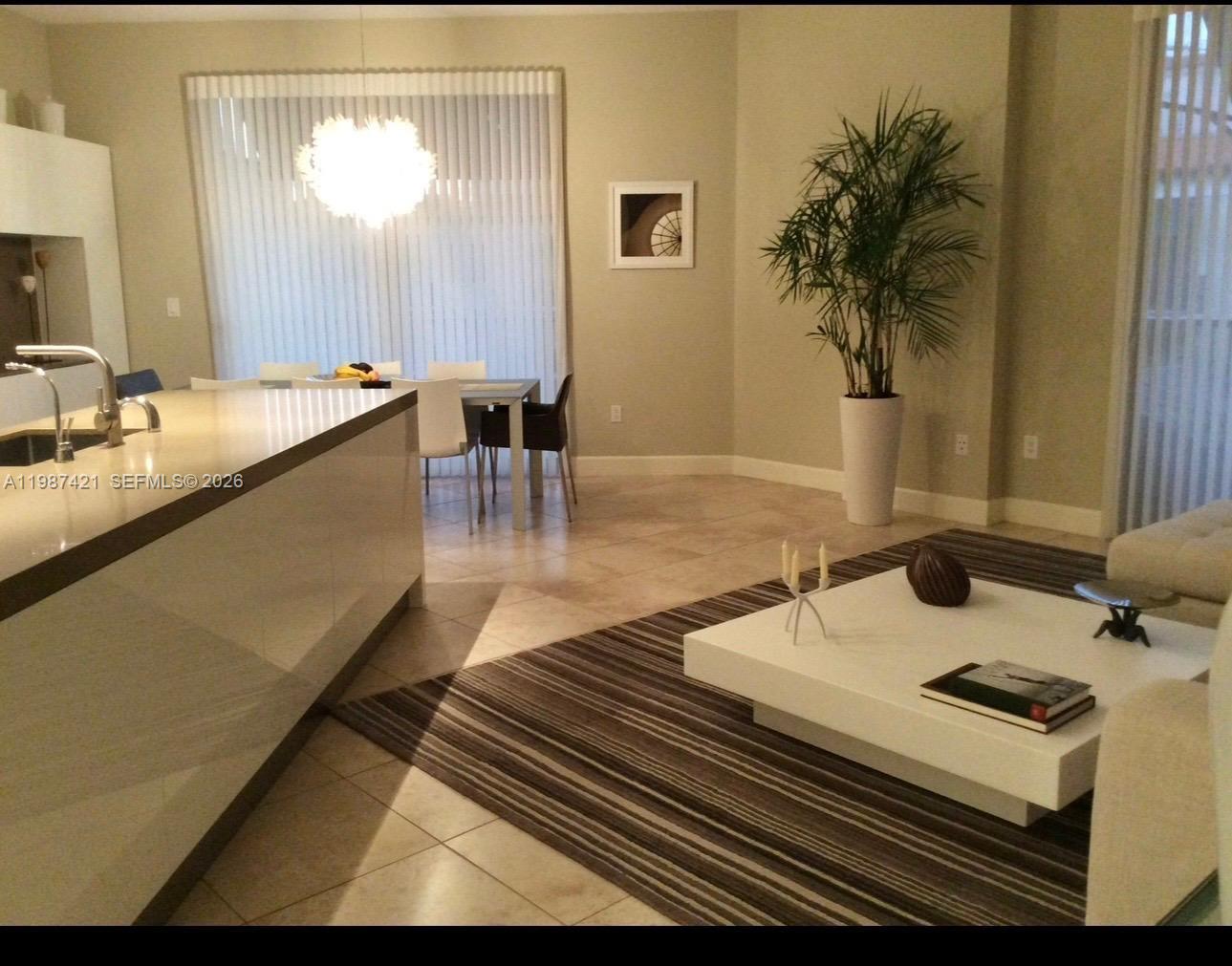 55 Merrick Way, Unit 825 Coral Gables, FL 33134 - Photo 6 of 26 a kitchen with a sink and a stove top oven