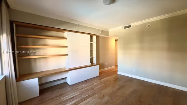 a view of walk in closet with empty racks