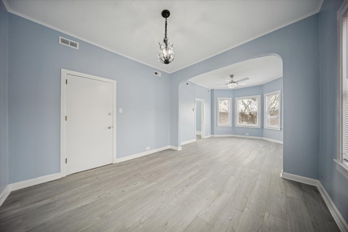 3134 West 39th Place, Unit 2 Chicago, IL 60632 - Photo 5 of 12 wooden floor in an empty room with a window