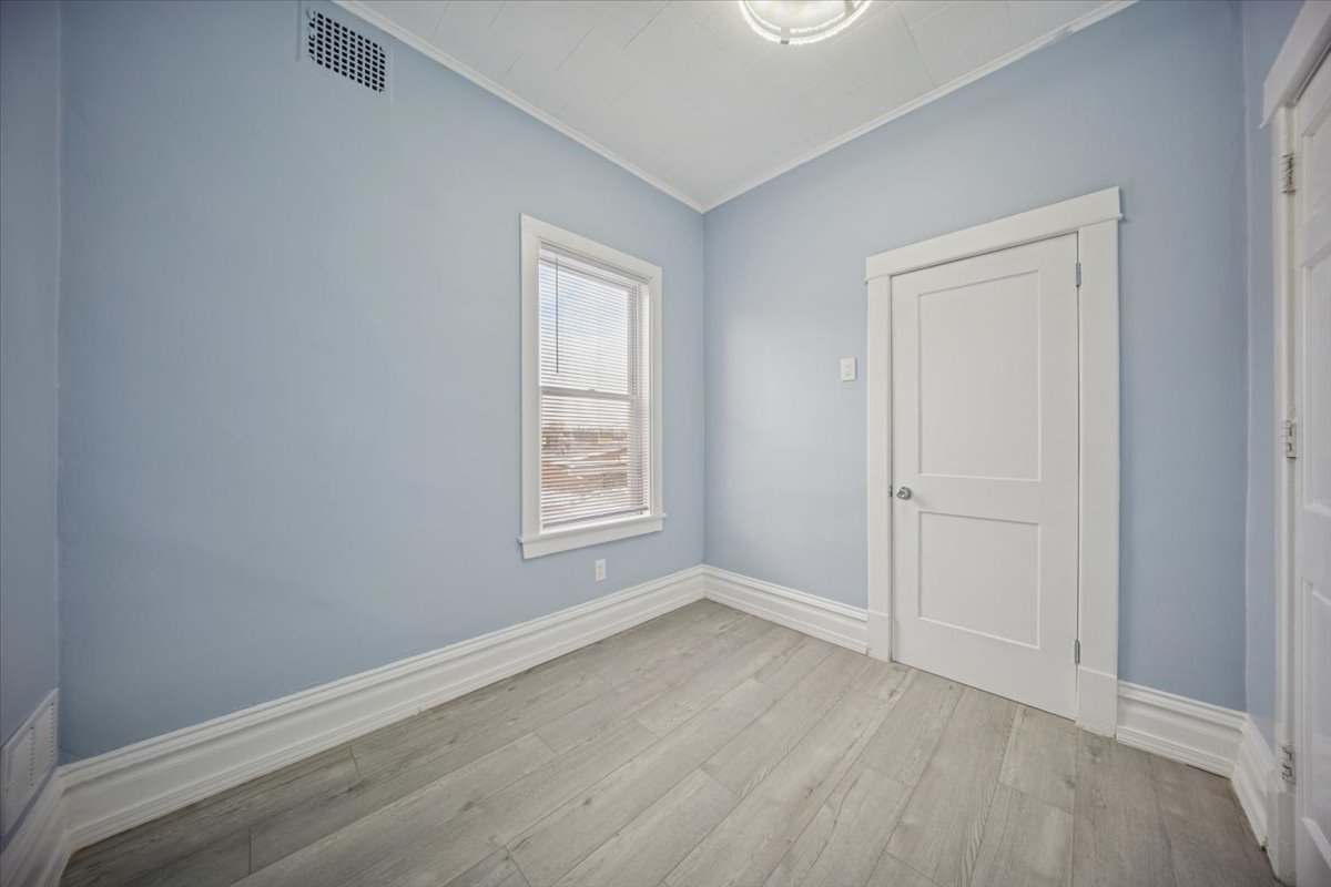 3134 West 39th Place, Unit 2 Chicago, IL 60632 - Photo 6 of 12 an empty room with wooden floor and window