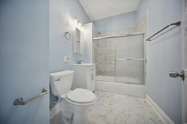 a white toilet sitting next to a bathroom sink