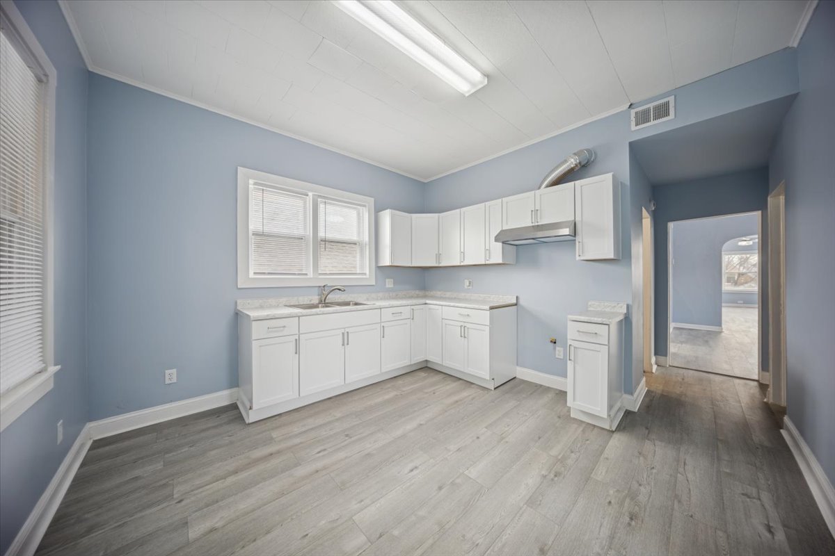 3134 West 39th Place, Unit 2 Chicago, IL 60632 - Photo 9 of 12 a kitchen with white cabinets and white appliances