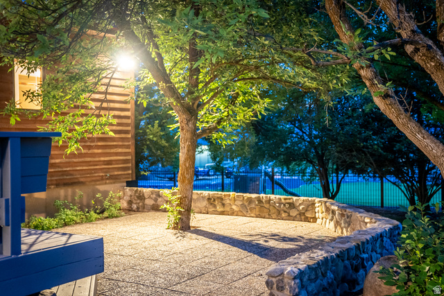435 Canyon Road Millville, UT 84326 - Photo 102 of 113 Patio area featuring exposed aggregate concrete surfacing and a curved stone retaining wall