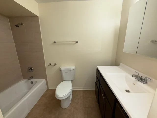 a bathroom with a sink a toilet and bathtub