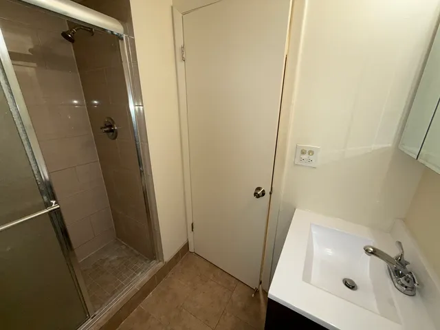 a bathroom with a sink and shower