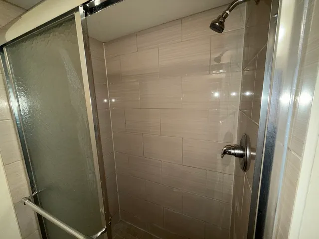 a bathroom with a glass door shower