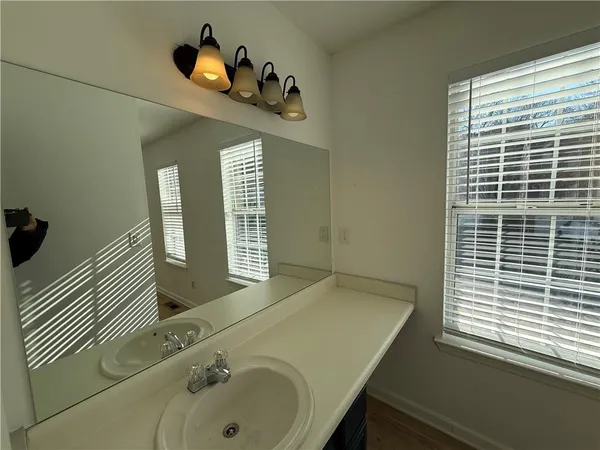 a bathroom with a tub sink and mirror