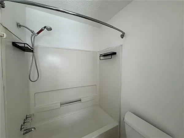 a bathroom with a shower and a bathtub