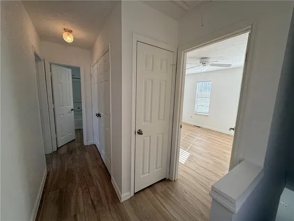 a view of a hallway with wooden floor