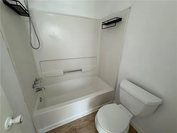 a bathroom with a toilet and a shower