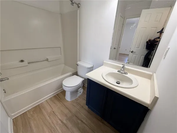 a bathroom with a sink toilet a mirror and shower