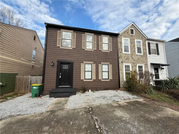 a front view of a house with a yard