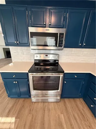 a kitchen with granite countertop a stove and a microwave oven