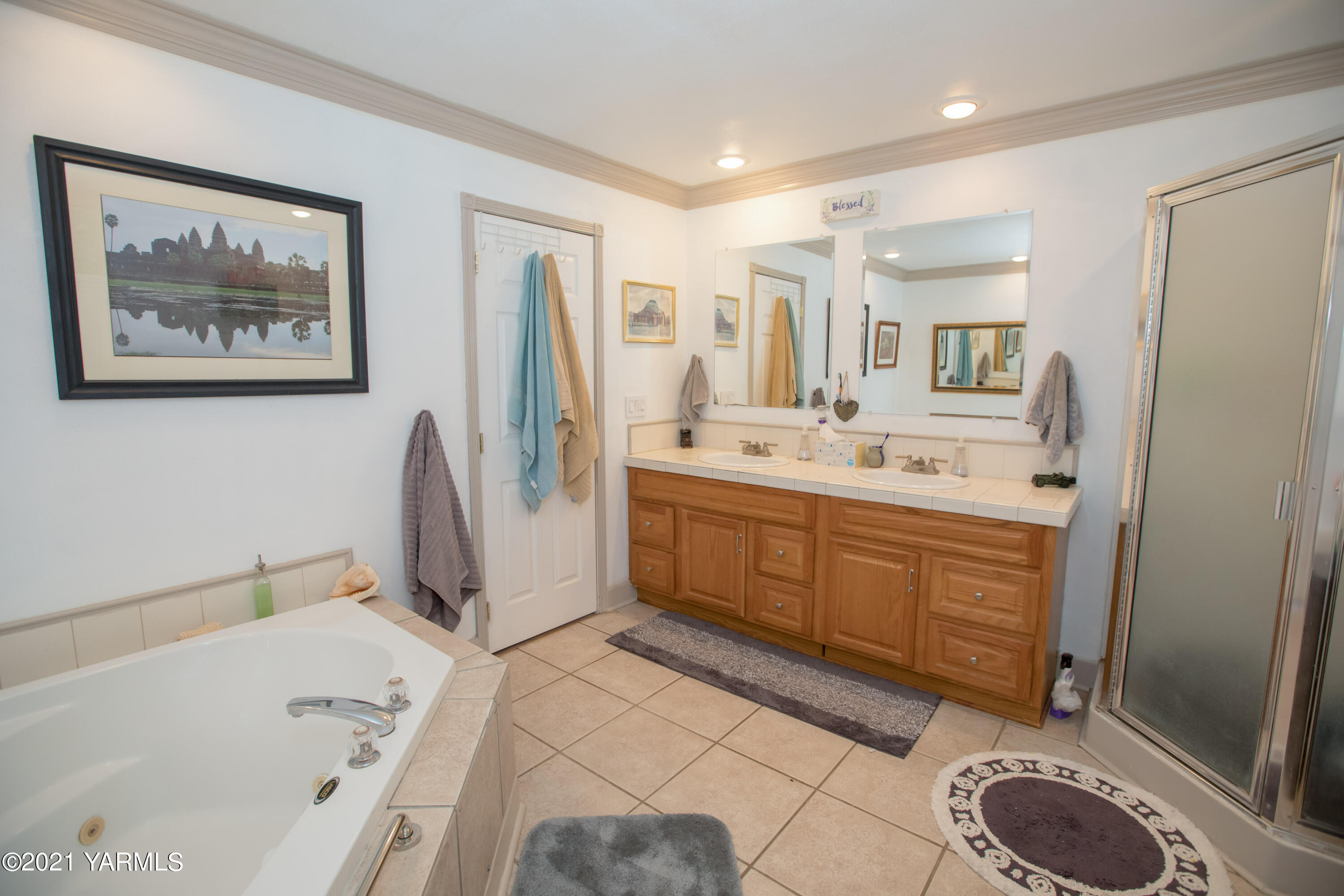 11401 Flintstone Road Yakima, WA 98908 - Photo 12 of 16 a spacious bathroom with a double vanity sink a mirror and a bathtub