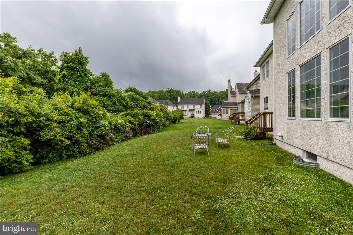100 Caleb Lane Princeton, NJ 08540 - Photo 36 of 38 a view of a big yard with plants and a bench