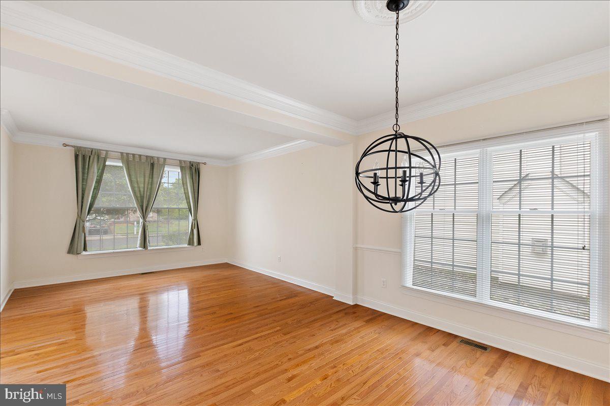100 Caleb Lane Princeton, NJ 08540 - Photo 8 of 38 a view of an empty room with wooden floor and a window