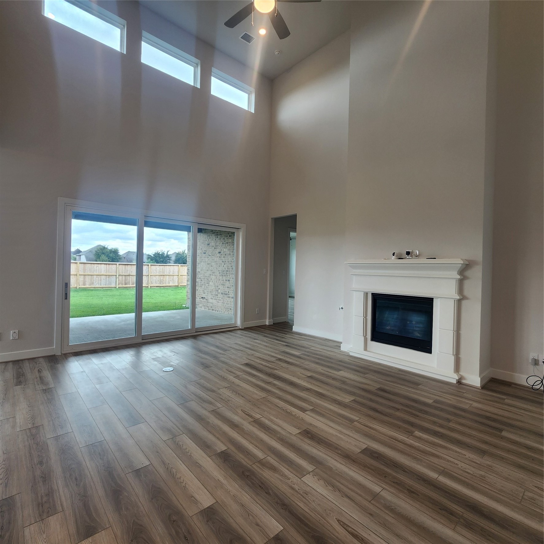 17507 Tulip Mdw Road Richmond, TX 77407 - Photo 15 of 47 an empty room with wooden floor fireplace and windows