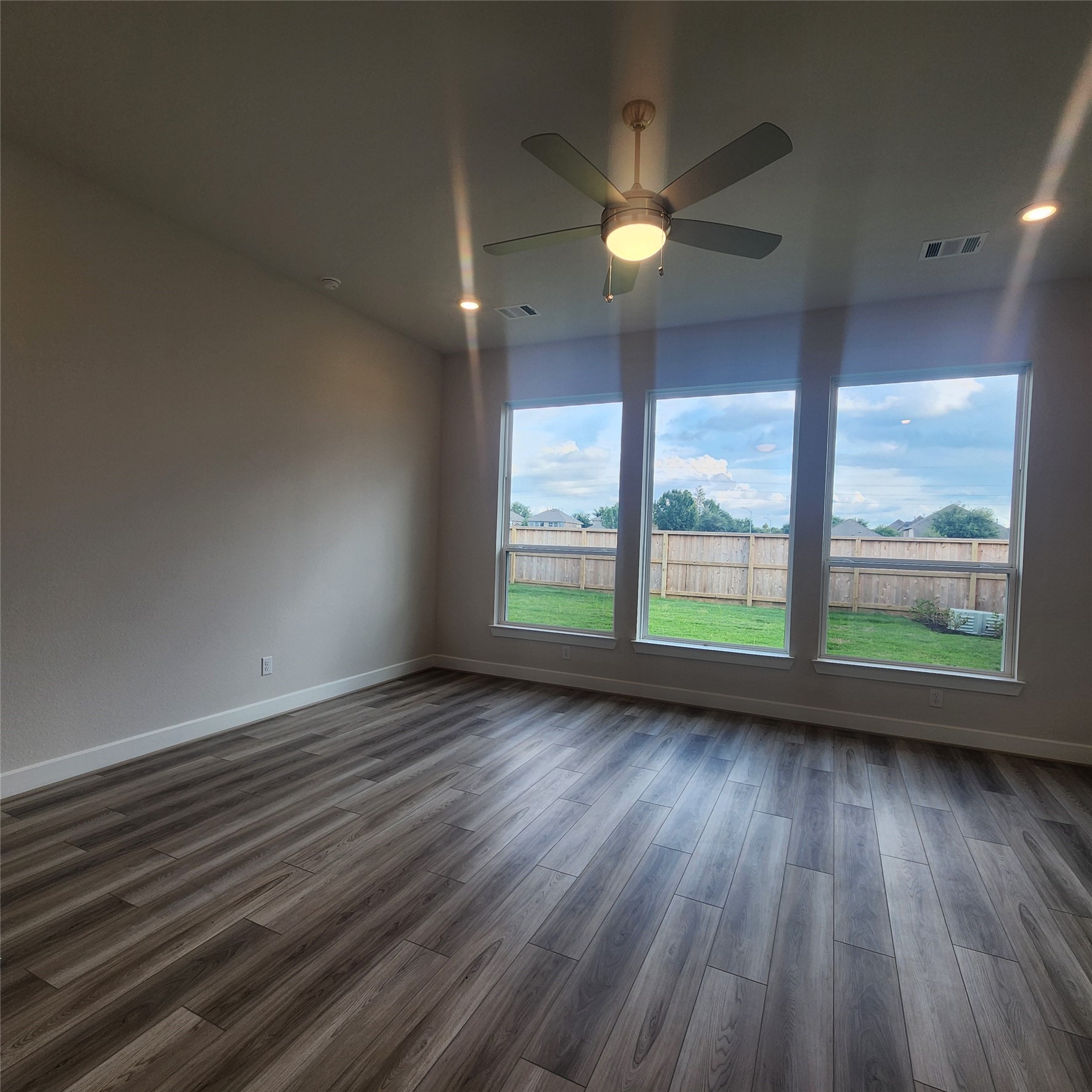 17507 Tulip Mdw Road Richmond, TX 77407 - Photo 18 of 47 an empty room with wooden floor and windows