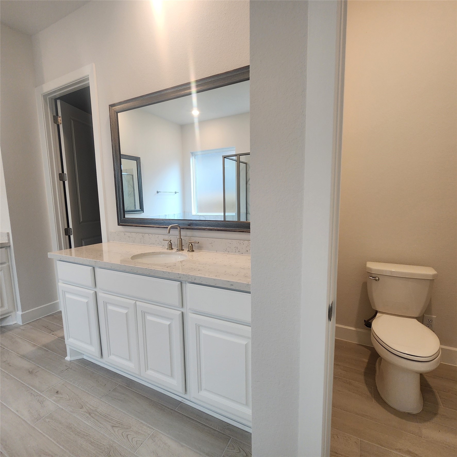 17507 Tulip Mdw Road Richmond, TX 77407 - Photo 22 of 47 a bathroom with a toilet a sink and mirror