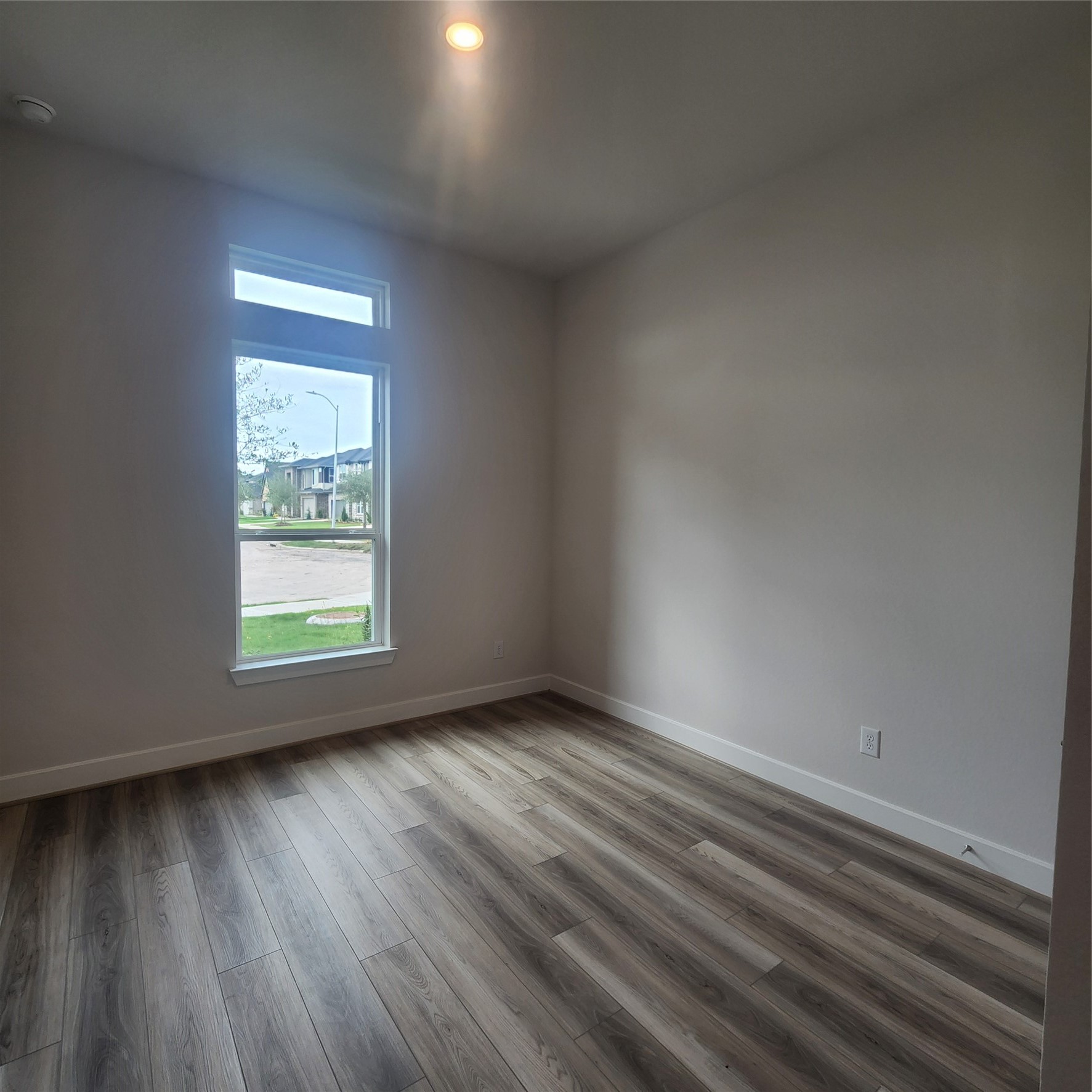 17507 Tulip Mdw Road Richmond, TX 77407 - Photo 26 of 47 an empty room with wooden floor and windows