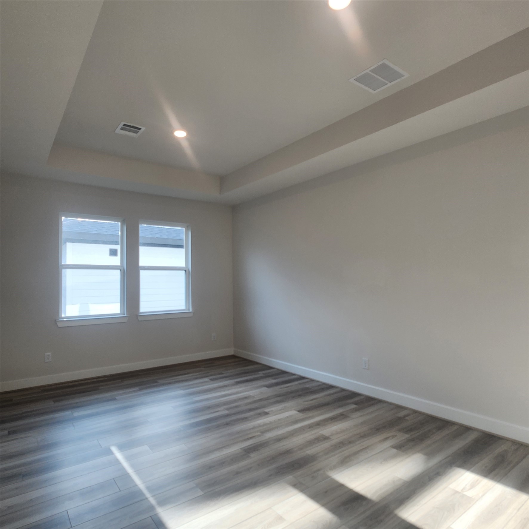 17507 Tulip Mdw Road Richmond, TX 77407 - Photo 28 of 47 an empty room with wooden floor and windows