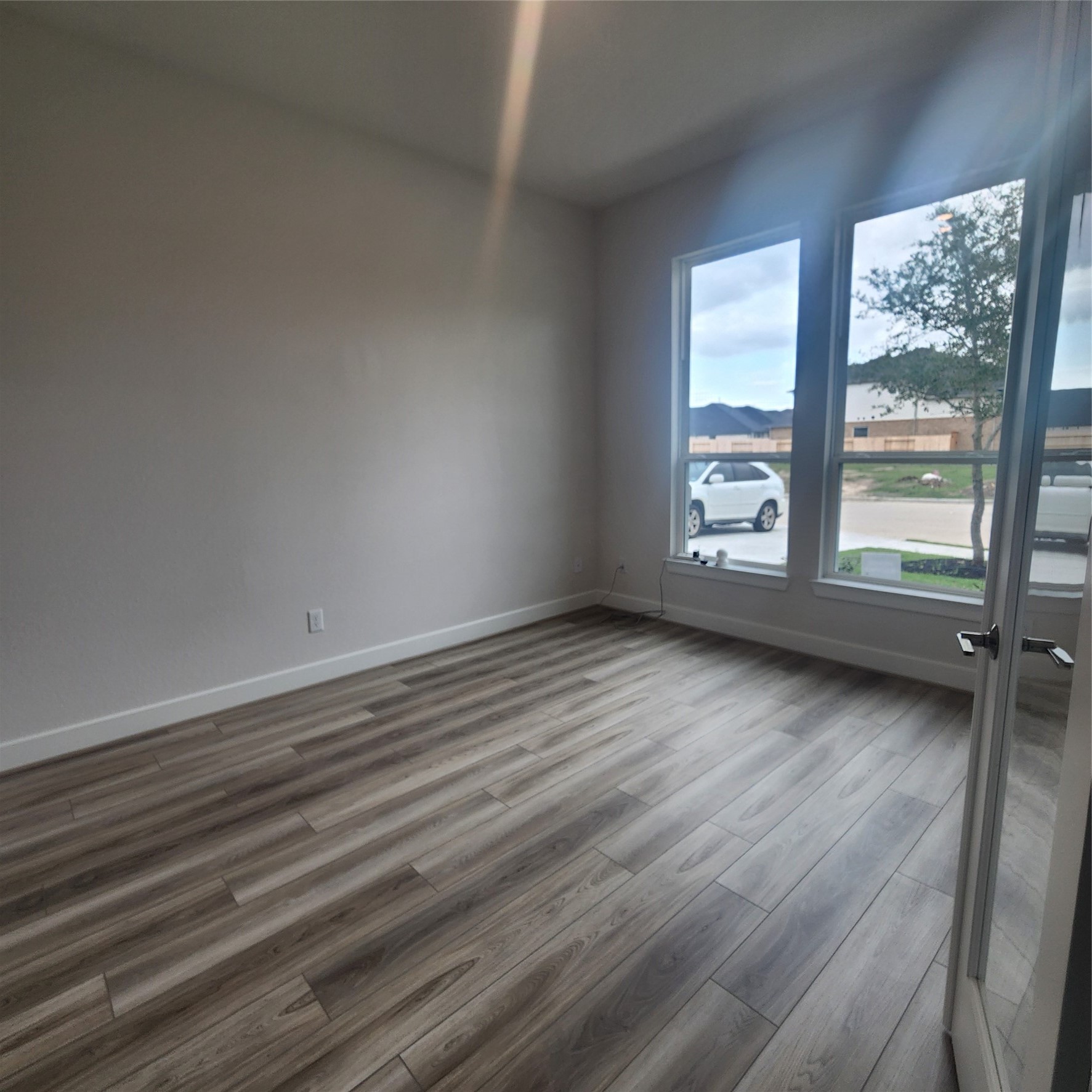 17507 Tulip Mdw Road Richmond, TX 77407 - Photo 5 of 47 wooden floor in an empty room with a window